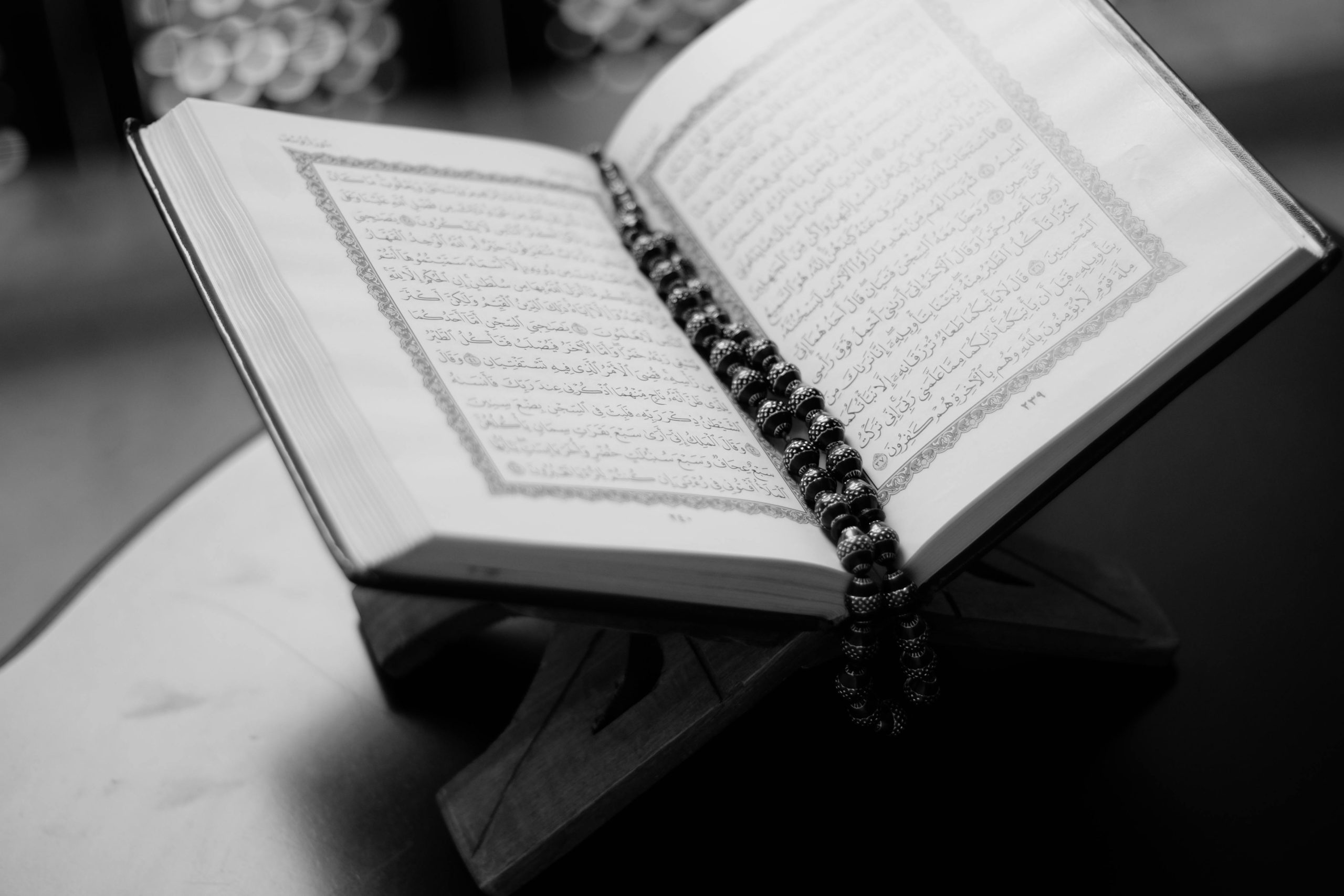 An open Quran with tasbih, symbolizing devotion for Quran Classes Online