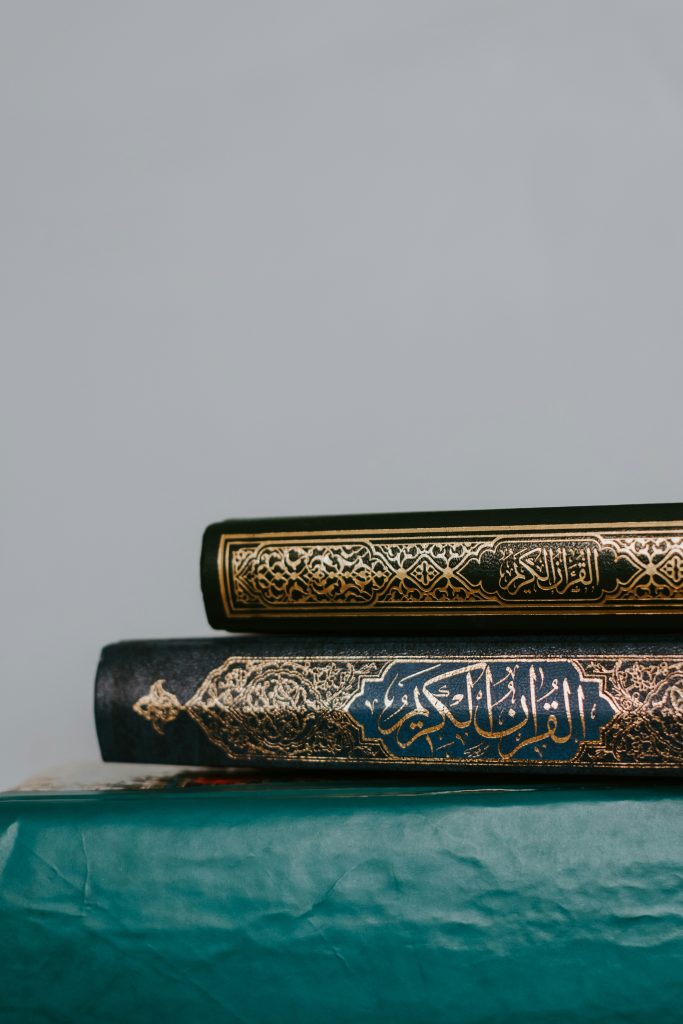 "Two Qurans on a blue table, learn via Online Noorani Qaida Course